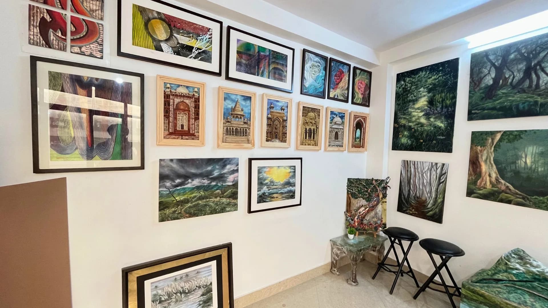 Wall of framed original paintings at Sejain Art Studio & Academy